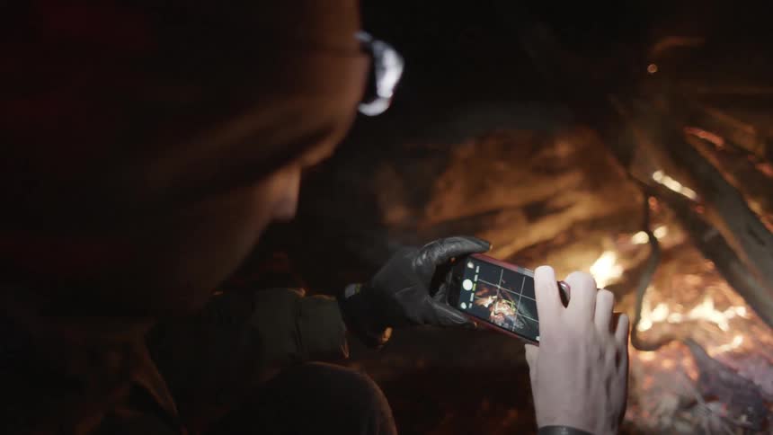 A man takes a picture of a fire