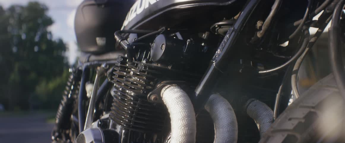 Close view of a motorcycle engine and workings on a cloudy day