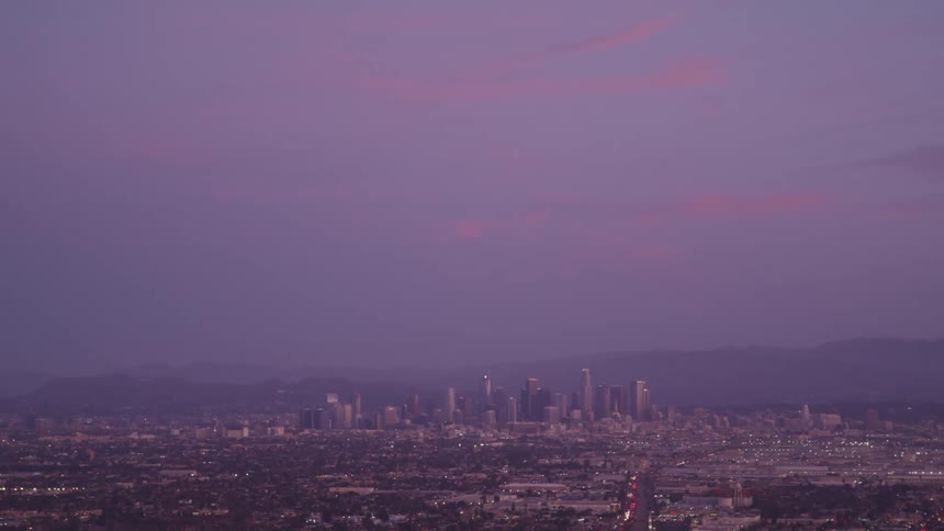 A metropolis under a purple evening sky