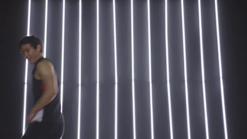 A teenage boy dancing on stage
