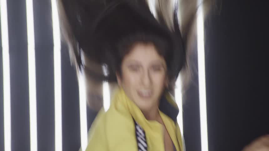 A woman spins in a circle while dancing