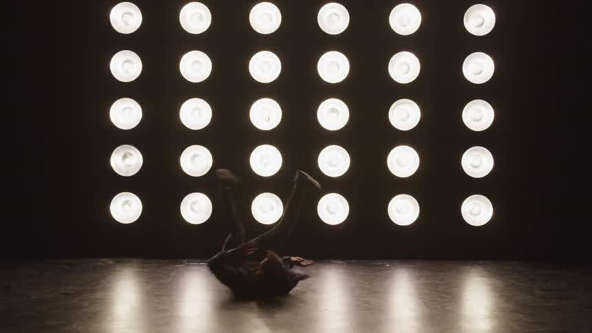 A teenage boy dancing on stage
