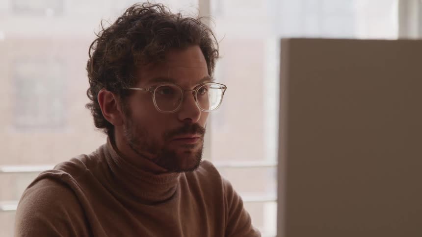 A man is looking at a display indoors