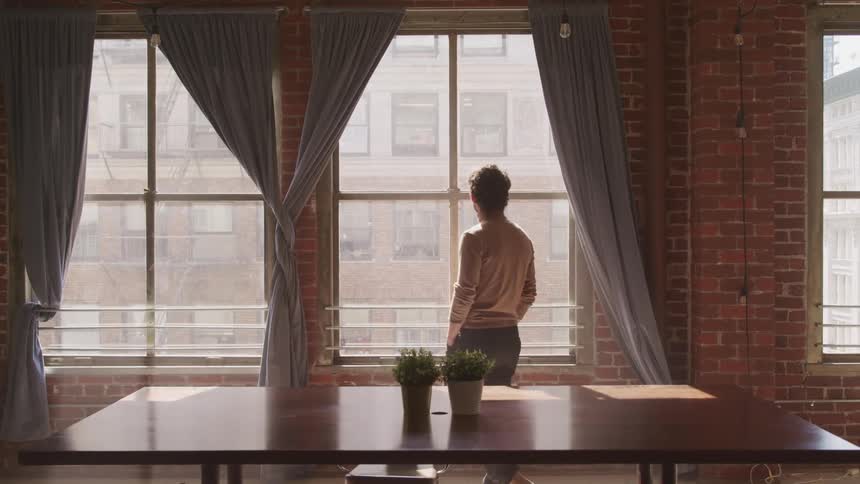 A man is walking in a room
