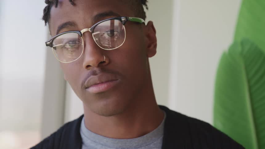 A black teenage boy standing in a home