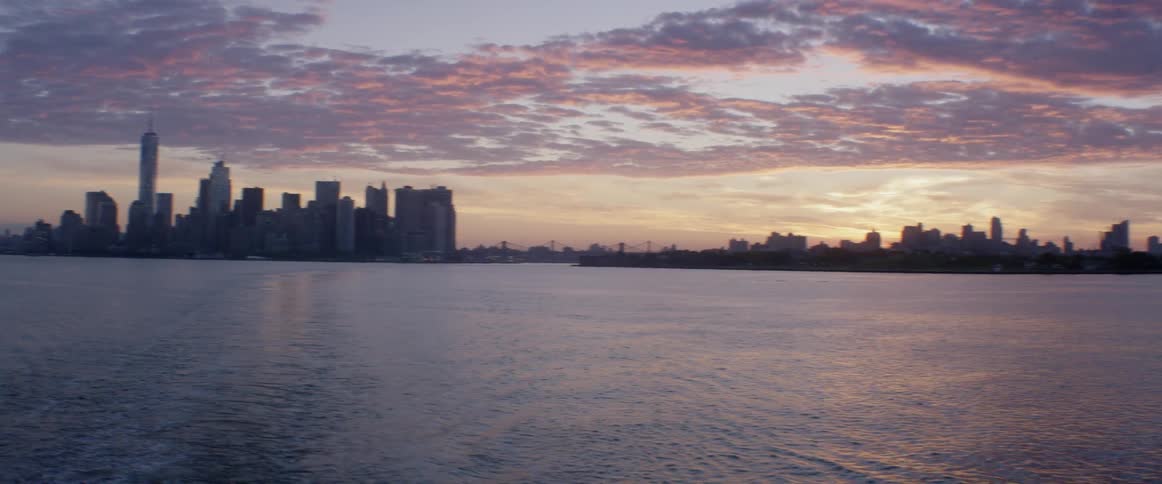 The skyline of a large city that sits beside water