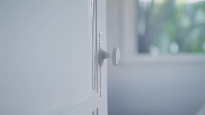 A white door knob on a white door