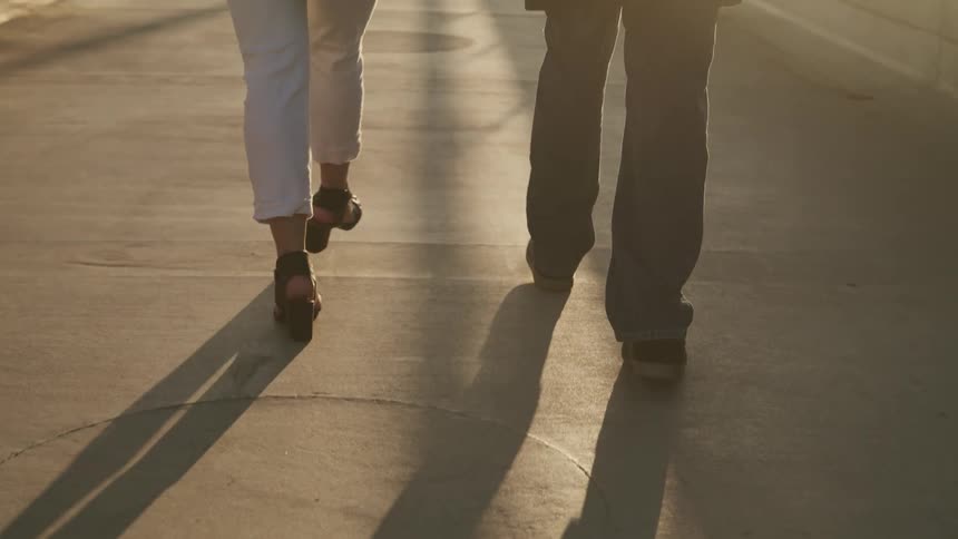 A woman and man are walking outdoors