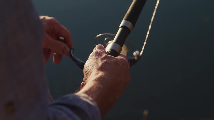 An elderly man fishing outside