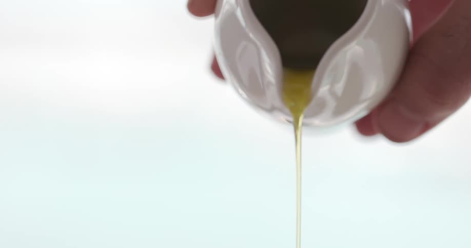 Oil pouring out of a ceramic container