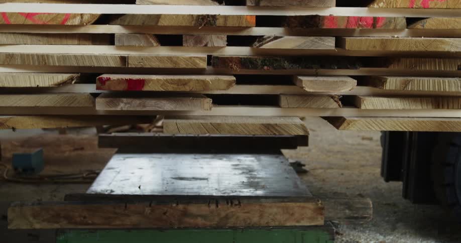 Forklift raises stack of pallet wood