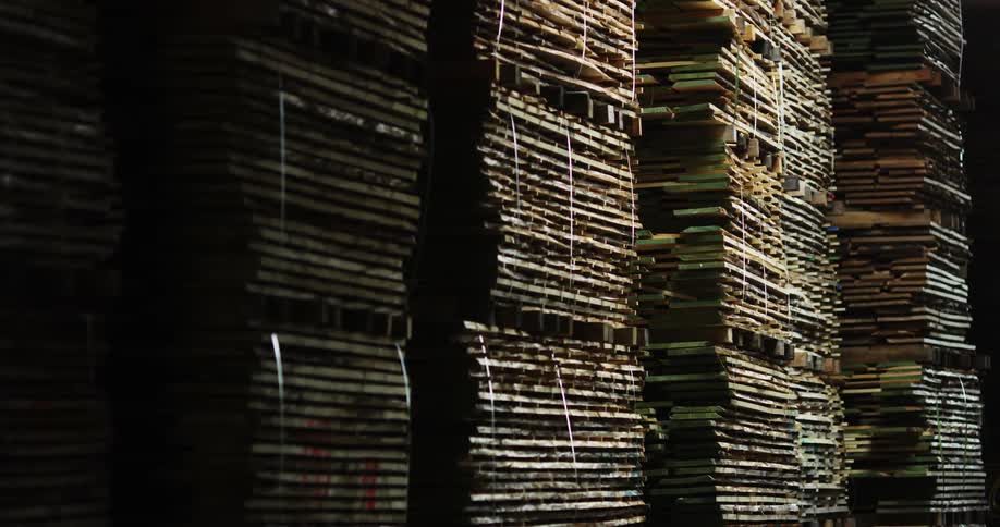 Stacks of lumber in a dark warehouse