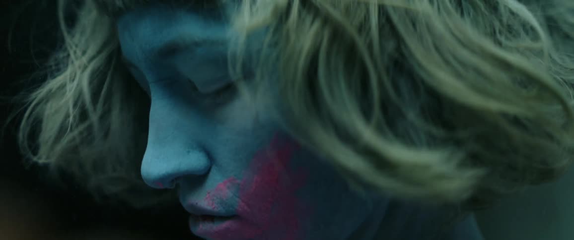 A young woman closes her eyes and shakes her head turning away from the camera