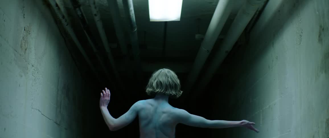 A woman is dancing in the dark tunnel
