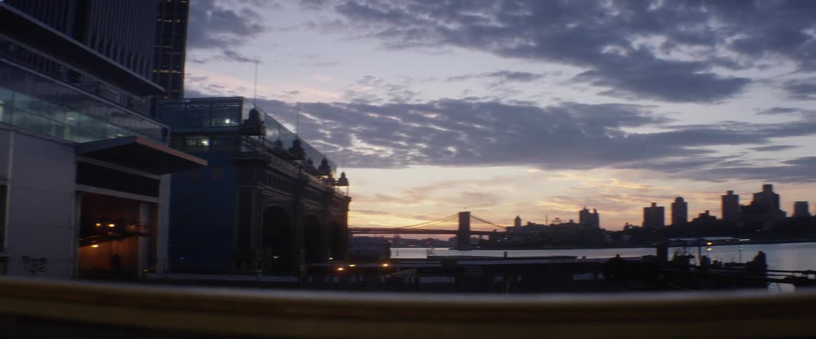 The sun is setting in the distance over a city