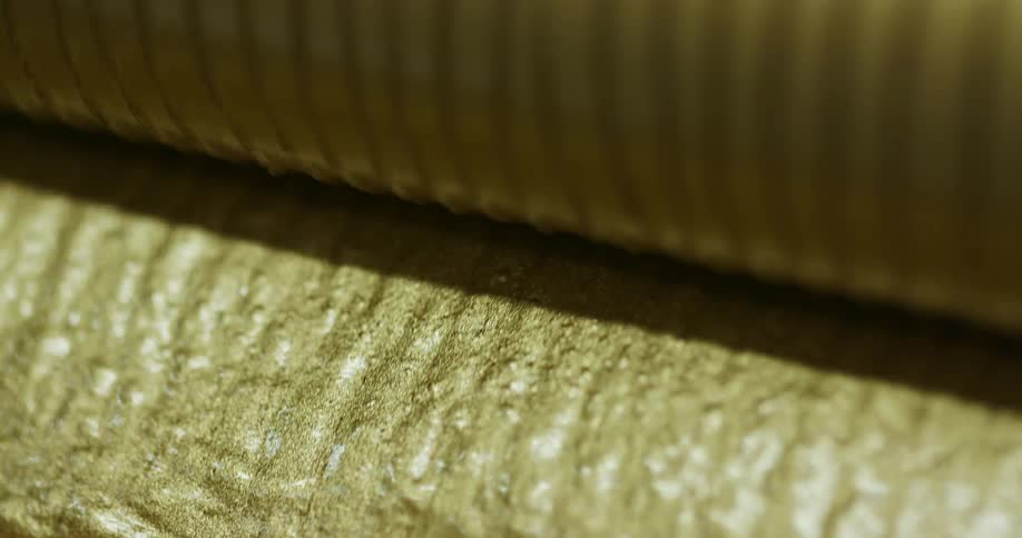 The roller moves gold liquid down