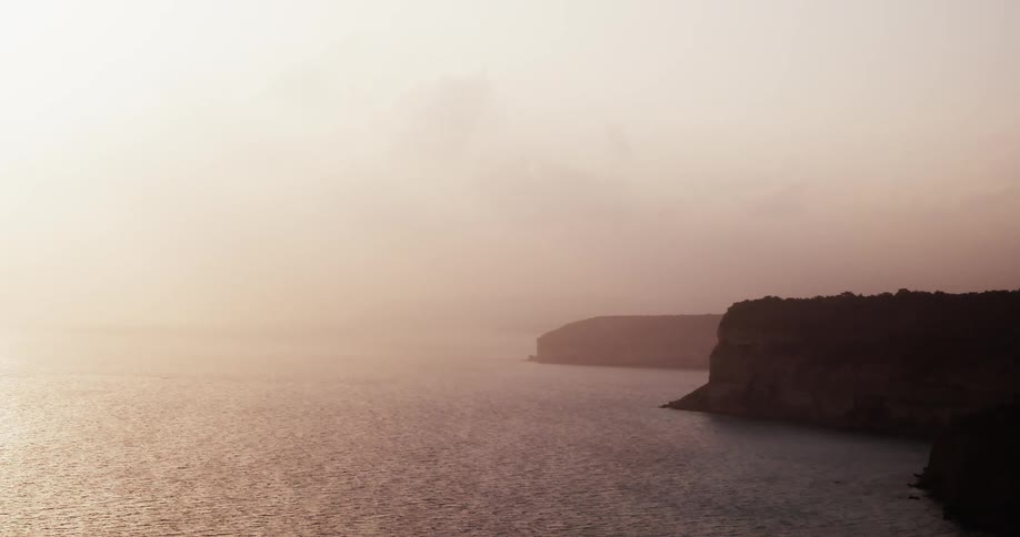 A coastal shoreline at sunset
