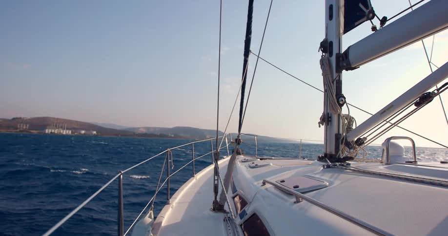 A white boat sails on an ocean