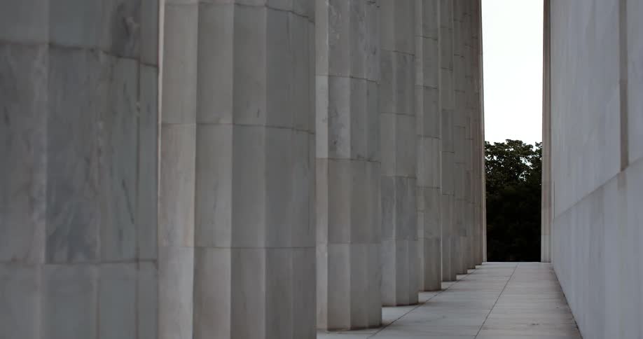 Columns line a walkway on a large stone building