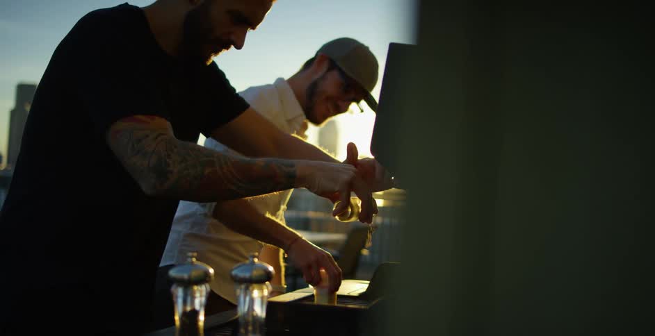 Two men cooking and grilling outside