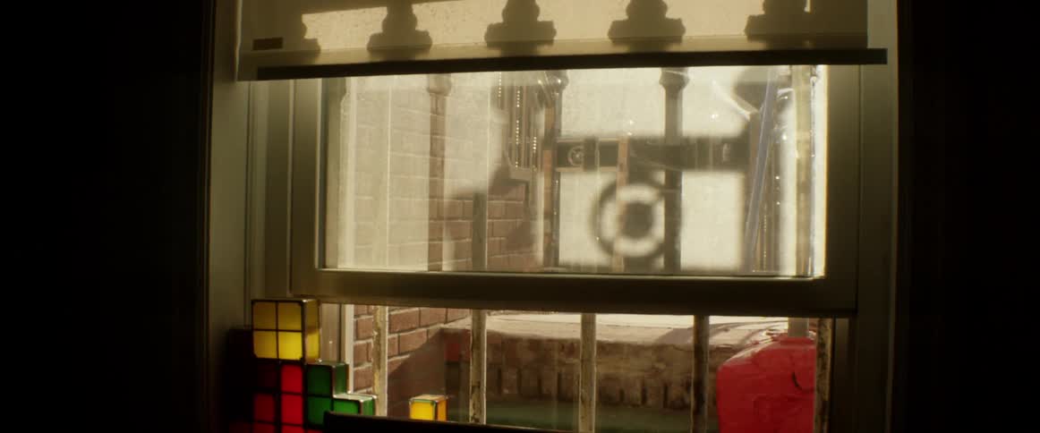 Sunlight makes reflections on window shade and window