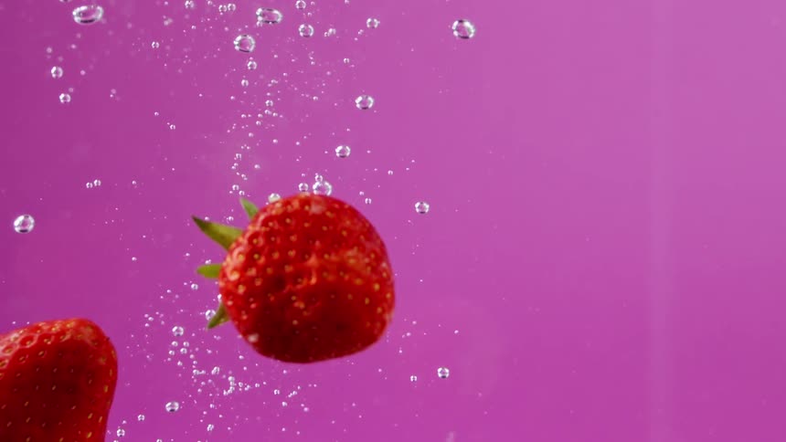 Strawberries falling in to water