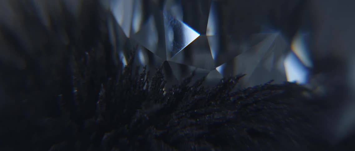 Strands of dark gray magnetic sand move and sway left to right