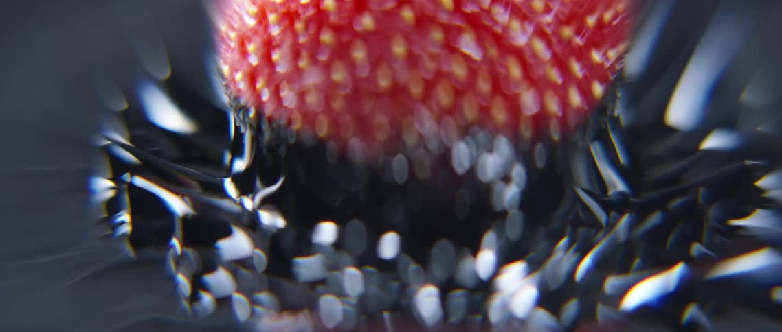 Dark liquid pulsing around a submerged strawberry