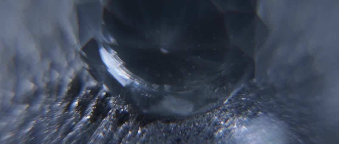 A close up of a crystal and metal shavings