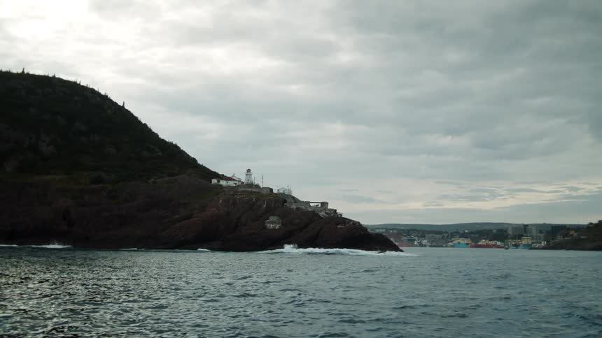 A lighthouse on a hill off the shoreline