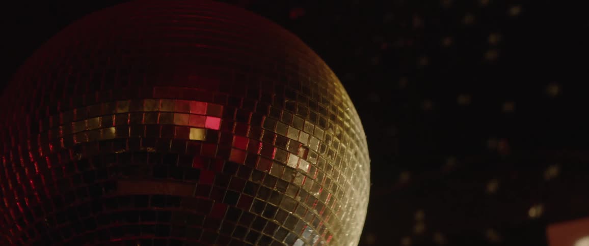 Disco ball spins and reflects light in a bar