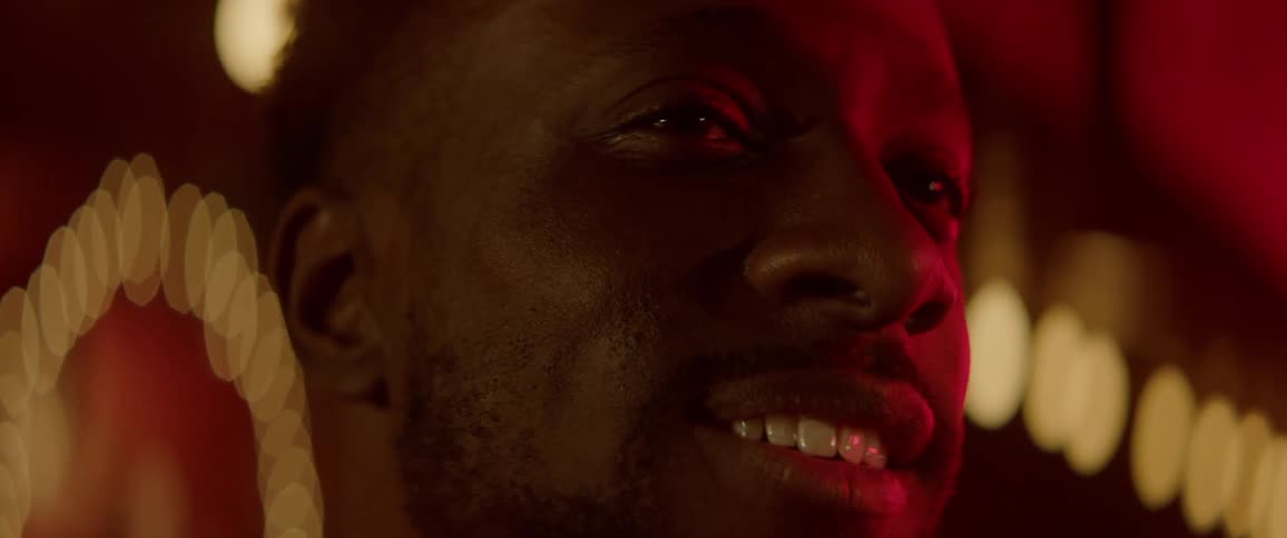 Close up of a young man in a bar smiling