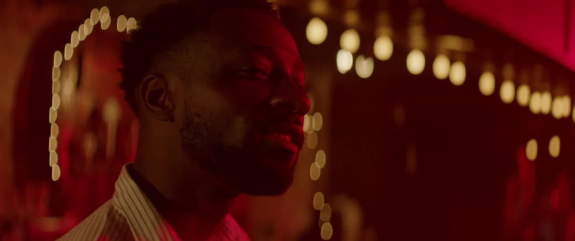 A man at a bar smiling