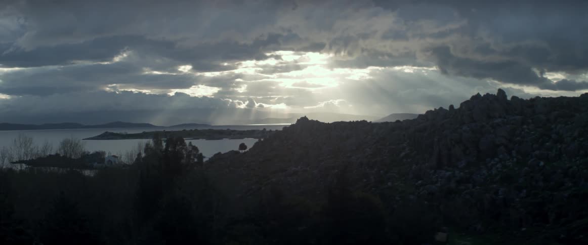 Sunlight shines through clouds in the wilderness