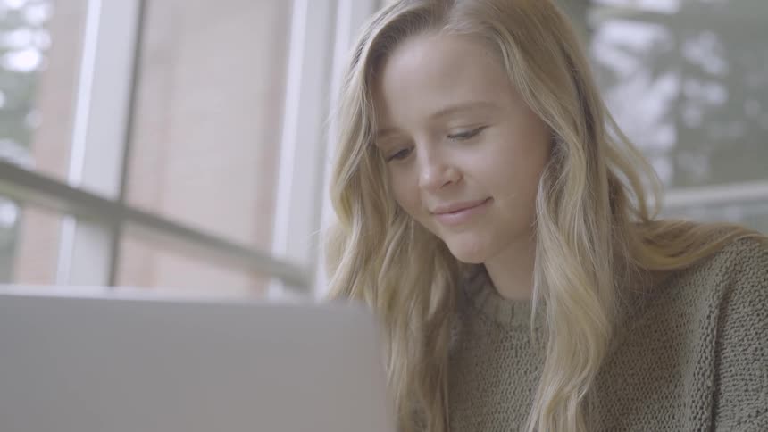 A woman is using a laptop