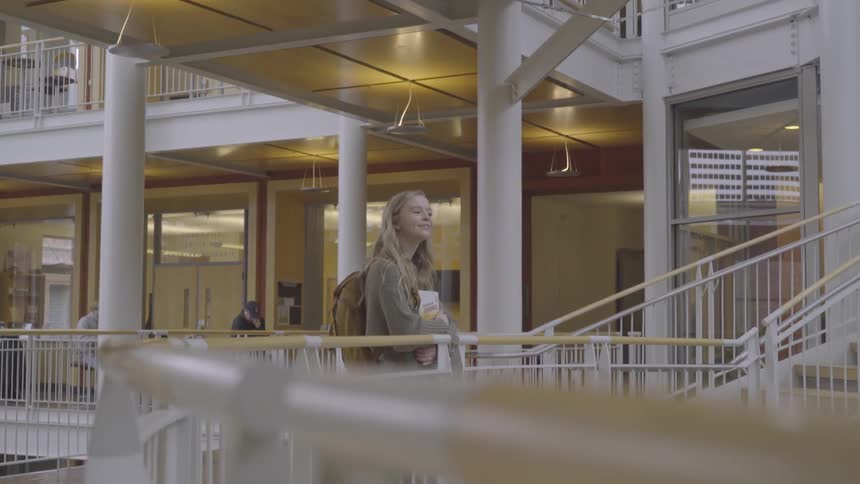 A woman looks around the large school building