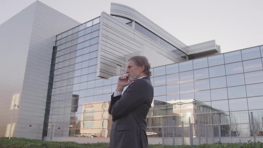 A man is standing outside a building