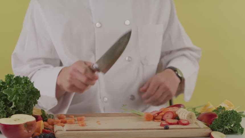 A person cuts an apple after throwing it