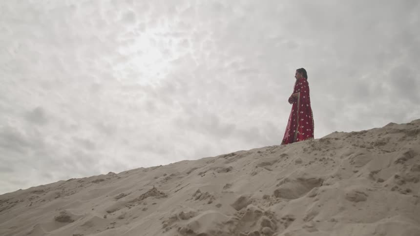 A woman standing on a beach
