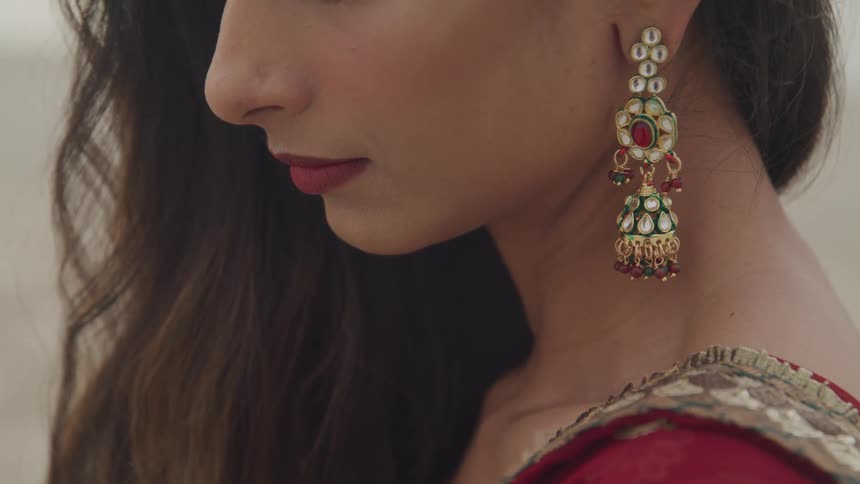 A woman is wearing earrings indoors