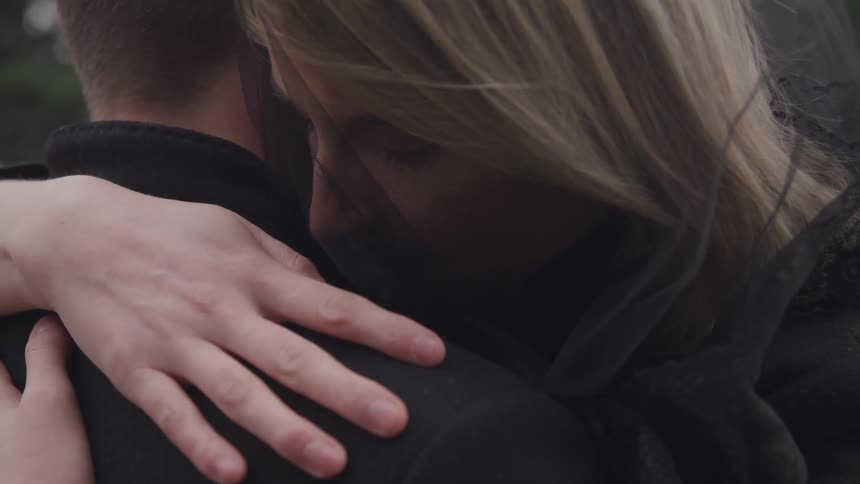 Two people are hugging outdoors in spring