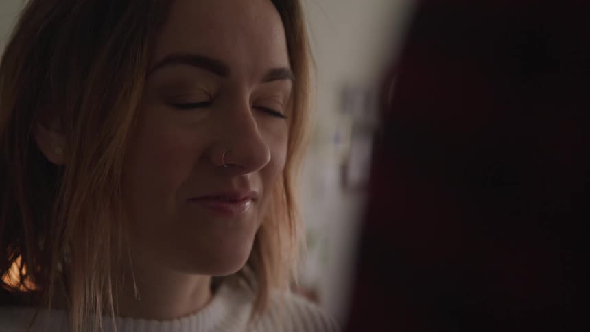 A teenage girl looks up at someone and smiles