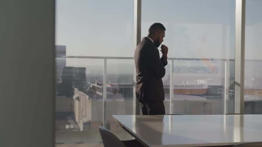 A man is walking around his office