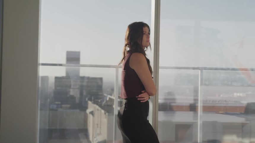 A woman is walking past the window