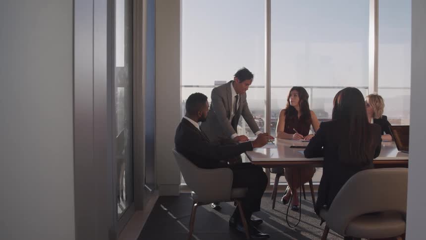 Business people conduct a meeting in a conference room