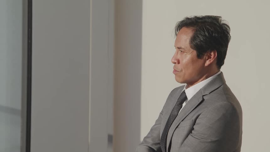 A man is standing in an office