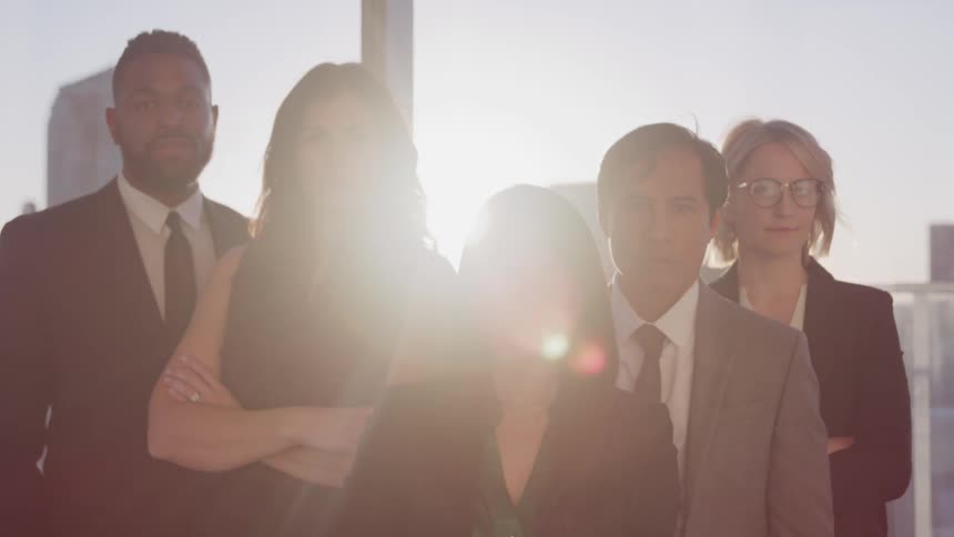 A group of office workers stand in front of the window