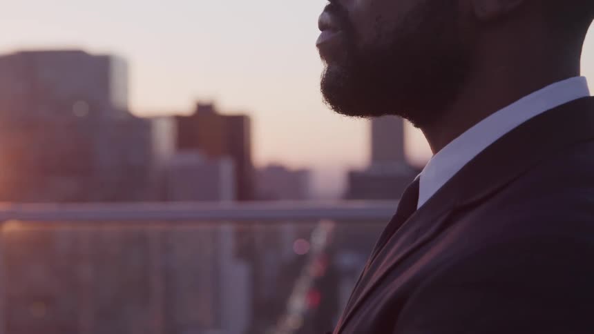 A man is watching the sunset from the roof