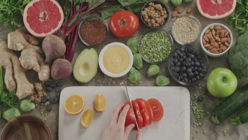 A woman cutting a tomato