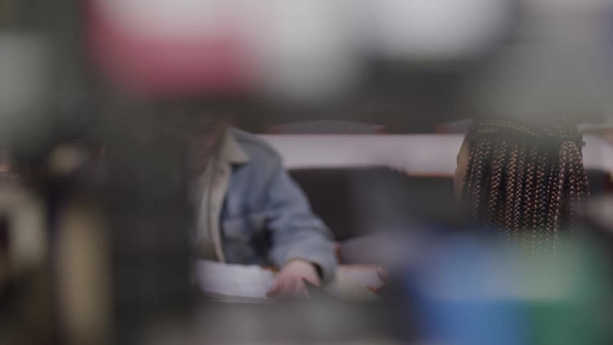 Two people in a school library talking